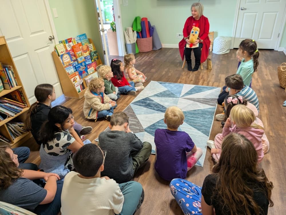 students sit in a circle on the floor