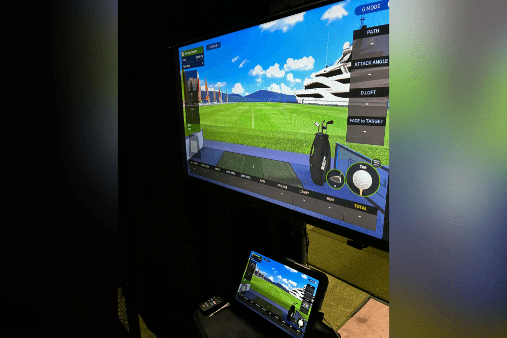 High-tech indoor golf facility in Kingwood with launch monitors and spacious practice bays