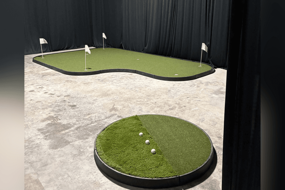 Spacious interior of The Practice Lab featuring multiple bays for golfers of all levels