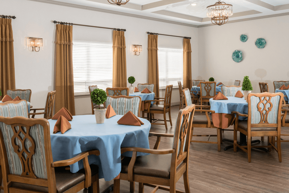 Lively indoor activity area with residents socializing at The Reserve at Richardson in Richardson. 