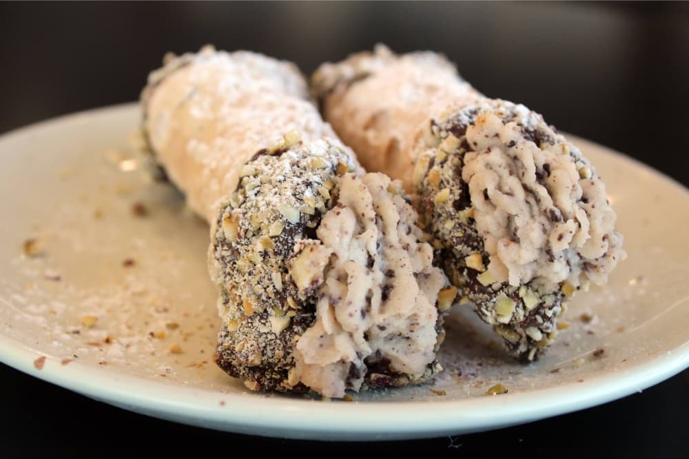 Two cannoli on a plate. 
