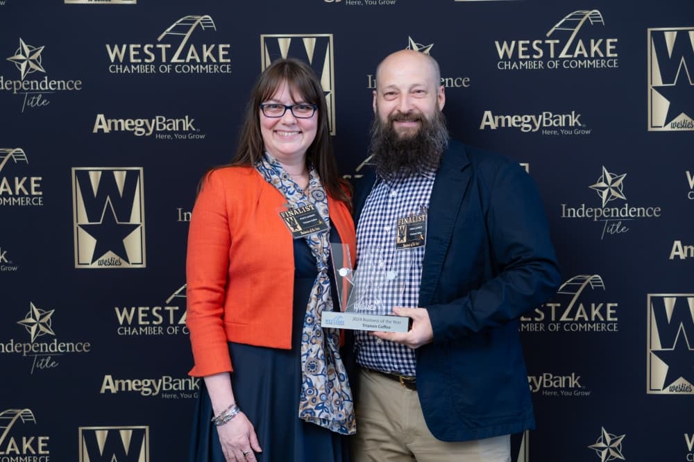man and woman posing with award 