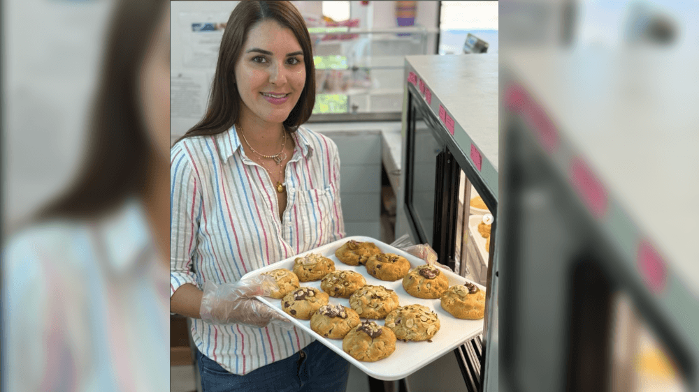 Radivojevich holding a tray of cookies
