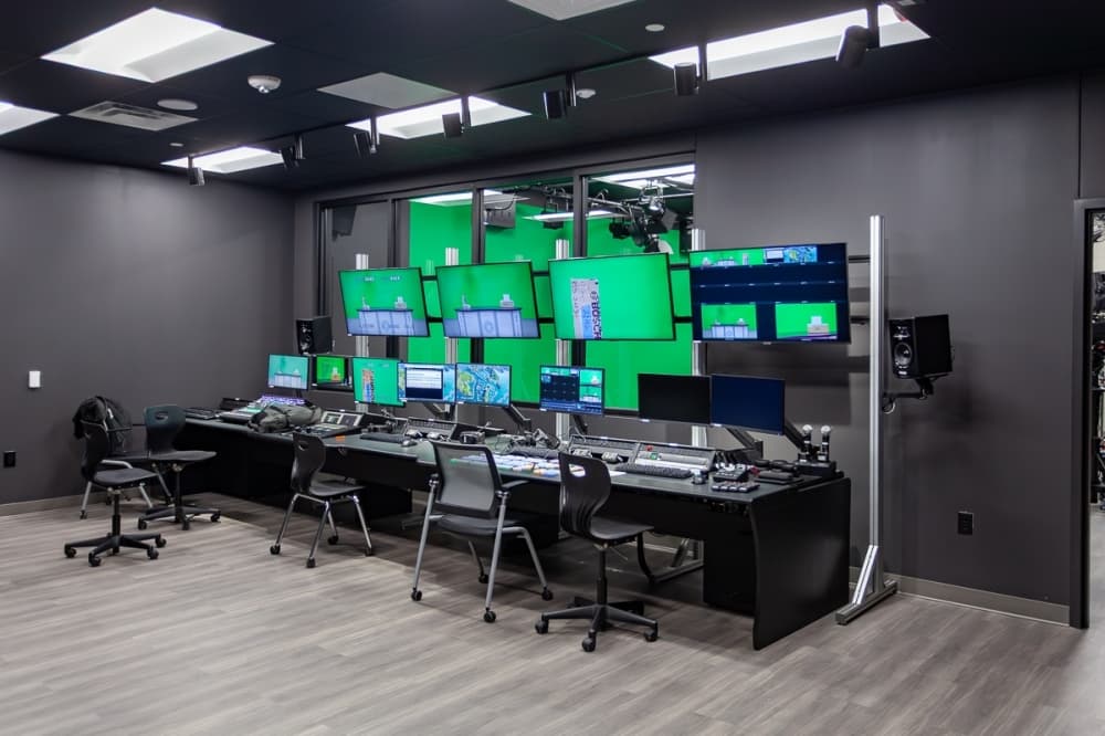 desk with monitors and computers