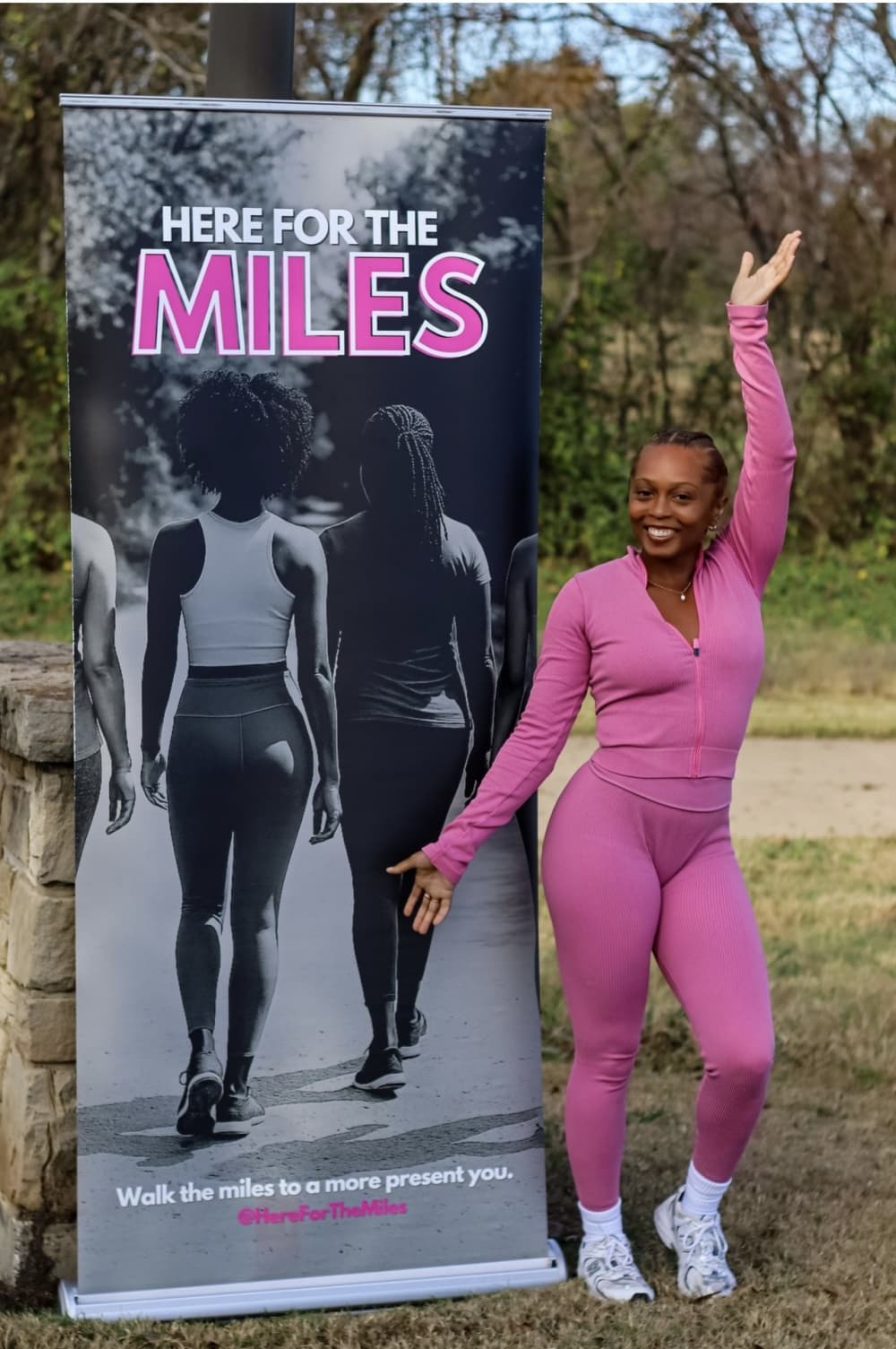Ieisha Davis poses next to a HFTM banner