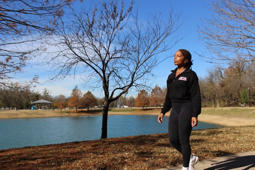 Ieisha Davis walking in front of a lake