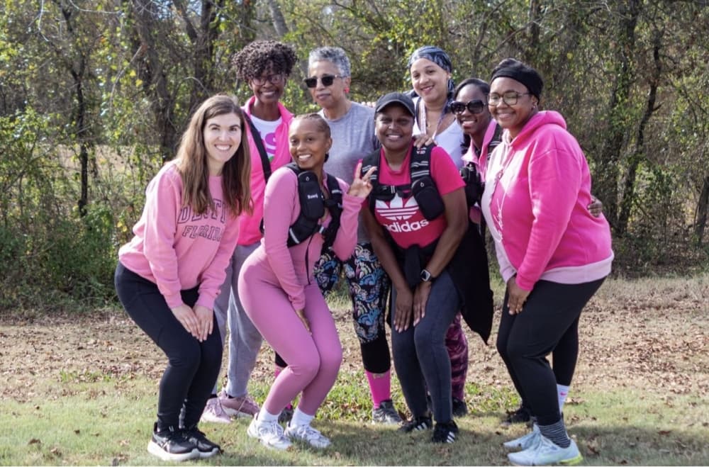 A group of women posing in pink athletic wear