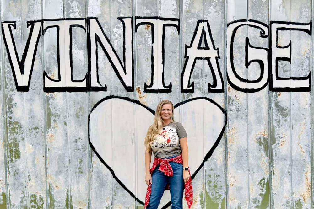 woman in front of a mural that says Vintage
