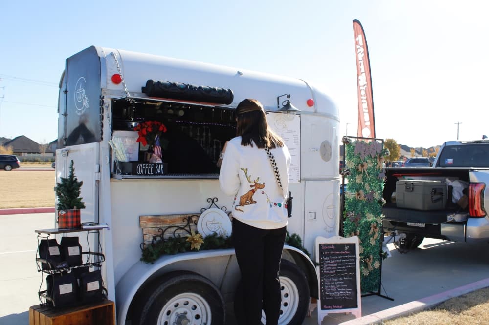 A customer ordering coffee out of the coffee trailer