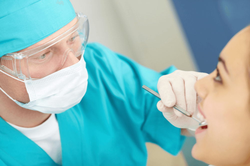 Dentist examining patient's teeth