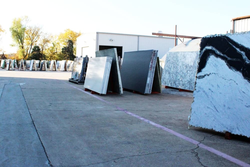 Slabs of stone displayed on a parking lot. 