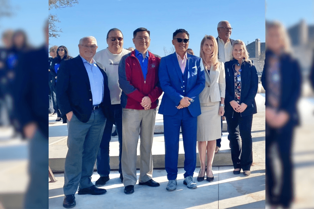 Dr. Pak posing with a group of people