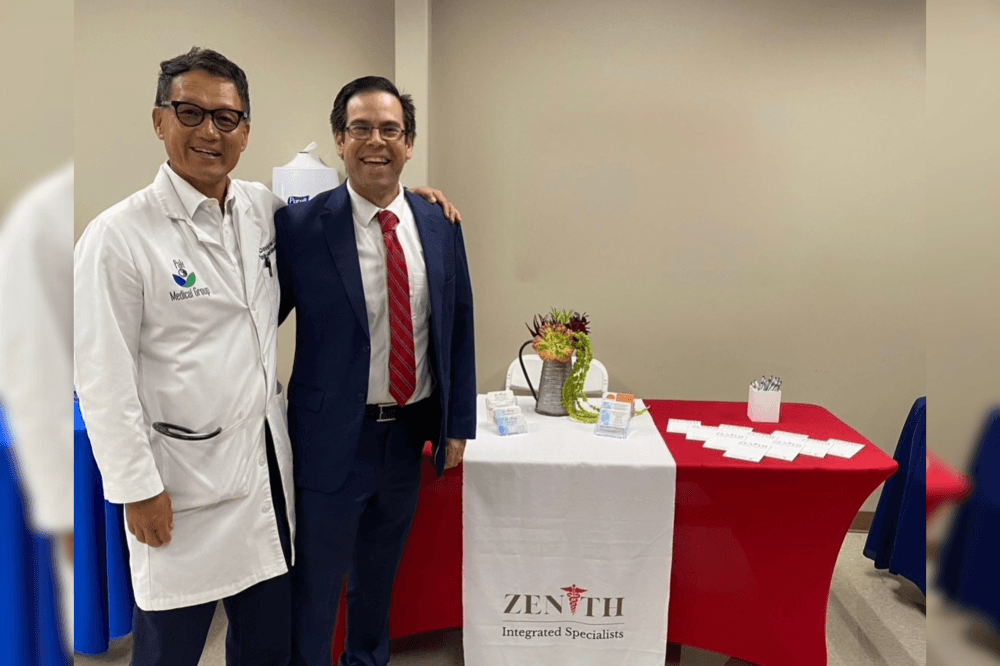 Dr. Pak posing with a man in a suit