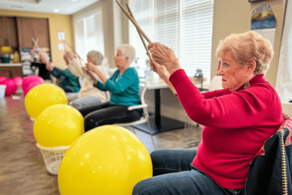 Senior living at The Solana Preserve Vintage Park showing residents participating in arts and crafts, cognitive programs, and social gatherings in a safe and vibrant retirement community.