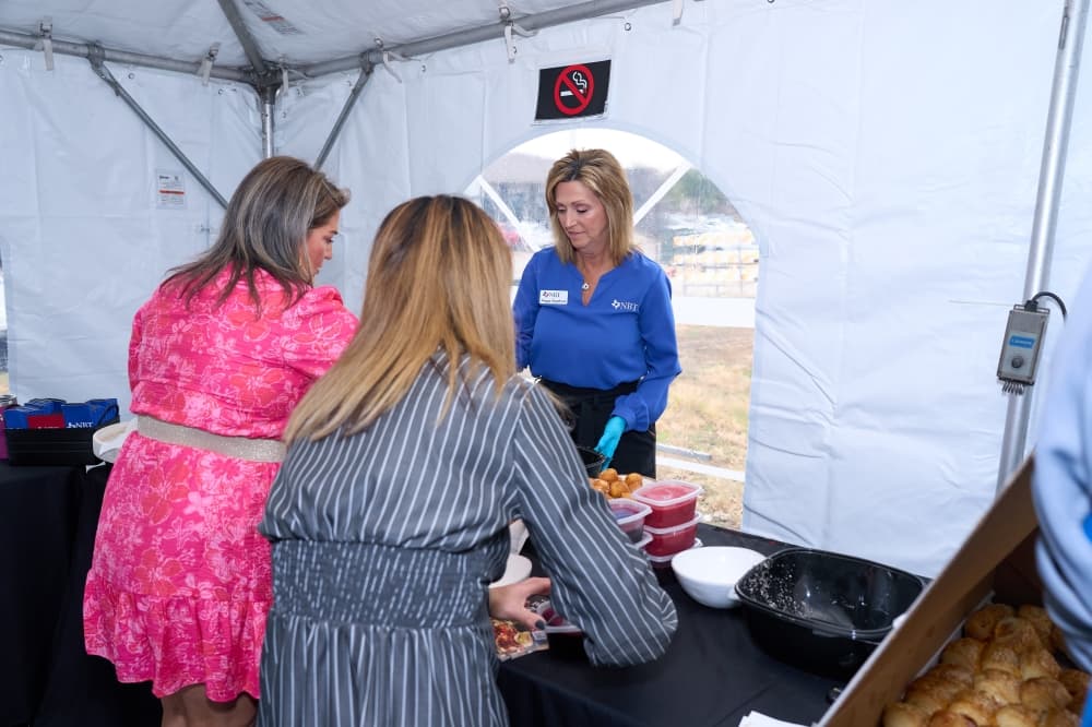 People getting food at groundbreaking event