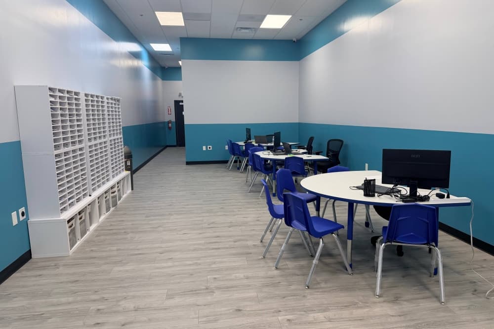 Inside a room featuring semi-circle tables with chairs around the table. 