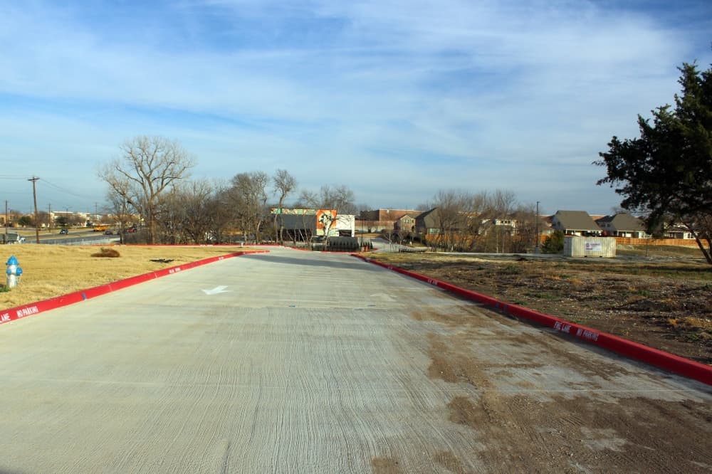 Road between two pieces of undeveloped land. 