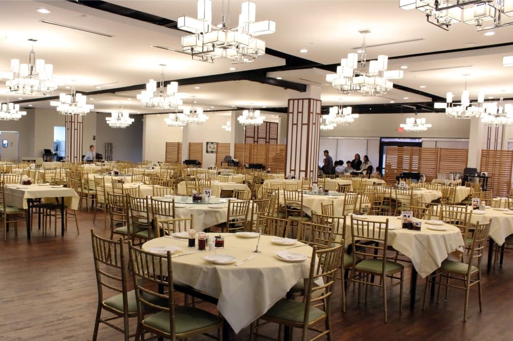 Interior of a restaurant featuring a white, gold and brown color scheme. 