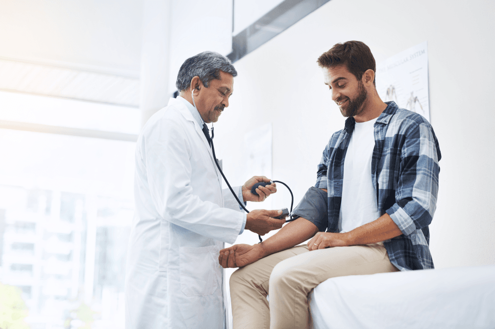 Doctor taking patient's blood pressure