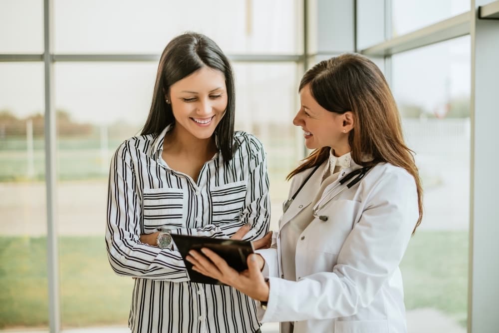 doctor showing patient lab results on tablet
