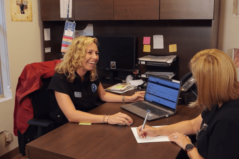 Staff members coordinating patient care at a desk