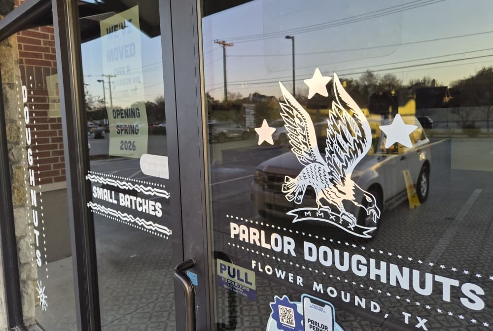 Parlor Doughnuts Flower Mound entrance with a flyer