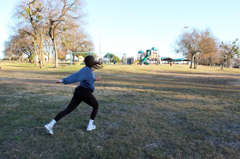 Garland resident Landry Baughman plays disc golf at Breckinridge Park. (Karen Chaney/Community Impact)