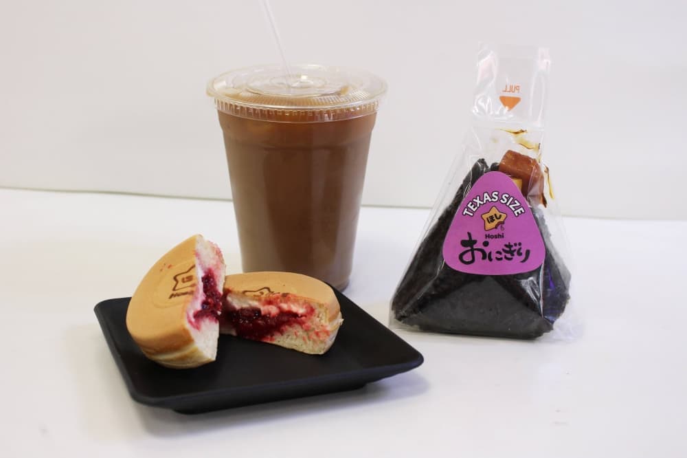 Two food items grouped together with a drink in a clear plastic cup. 