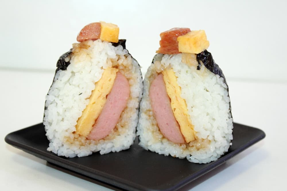 a large Japanese rice ball filled with spam and egg wrapped in seaweed