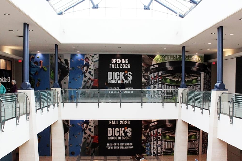 Two story part of a mall featuring Dick's House of Sport coming soon signage. 