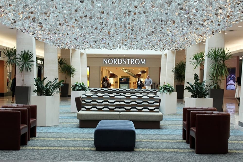 Decorative ceiling art hanging in a mall in front of a Nordstrom store. 