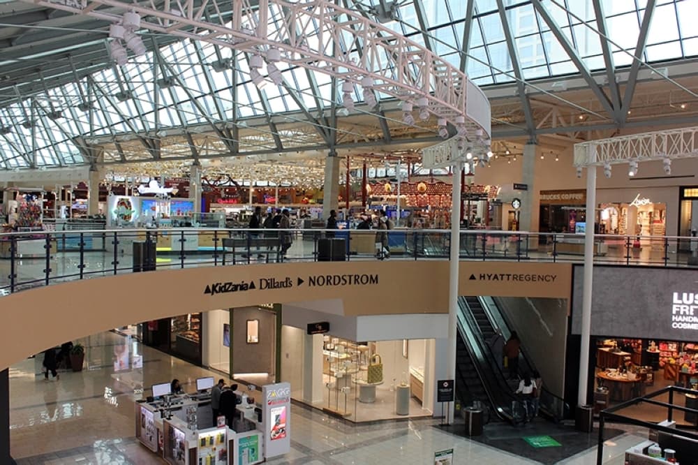 Upper story view of a mall featuring large glass ceiling panels.