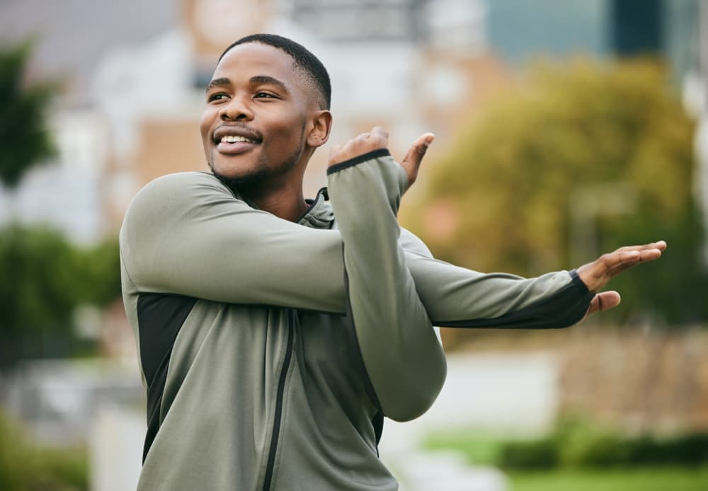 Man stretching in park