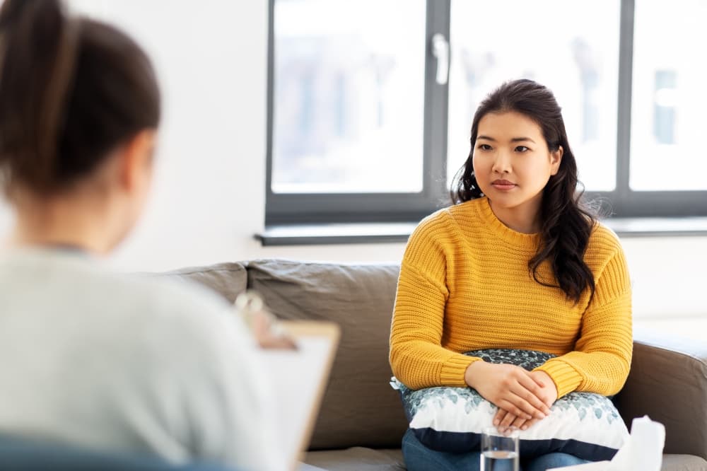 therapist talking to college student