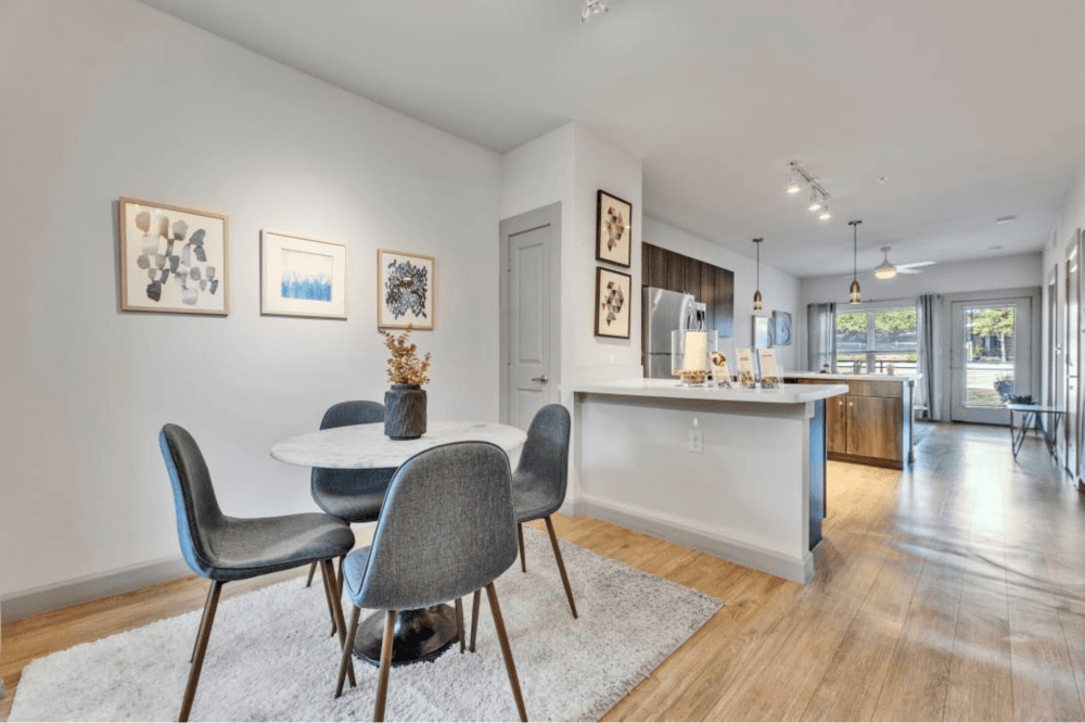 Spacious open-concept living room inside a Waters at Sunrise apartment featuring modern flooring, large windows, and contemporary design for comfortable everyday living