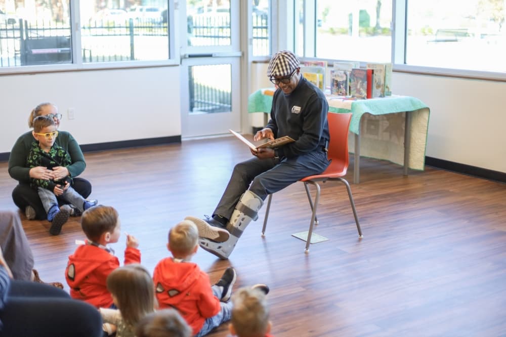 Mayor Baine Brooks reading a book to children
