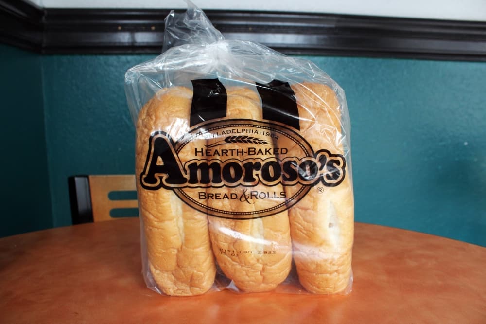 Sandwich bread in a clear plastic bag featuring Amoroso's branding. 