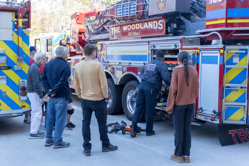 people gather around a fire truck