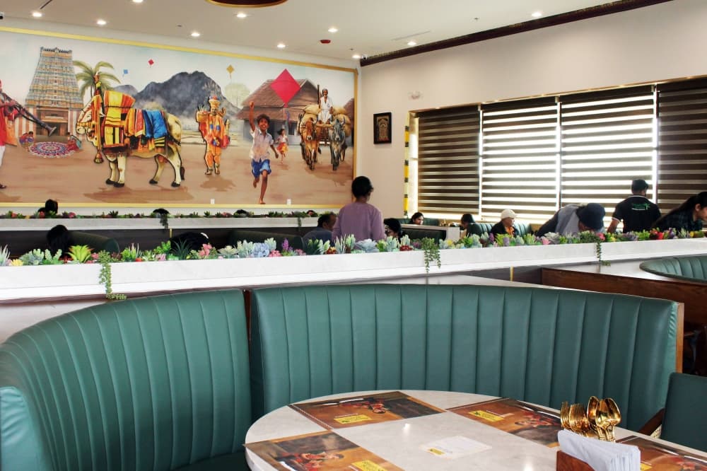 Interior of a restaurant with India-themed decor. 
