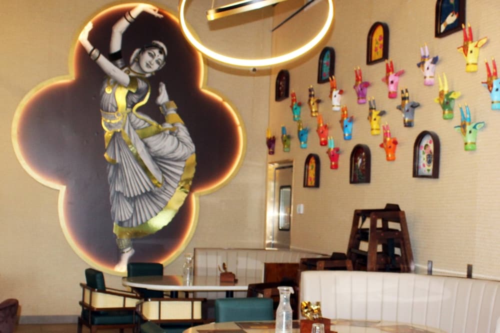 Interior of a restaurant with India-themed decor. 