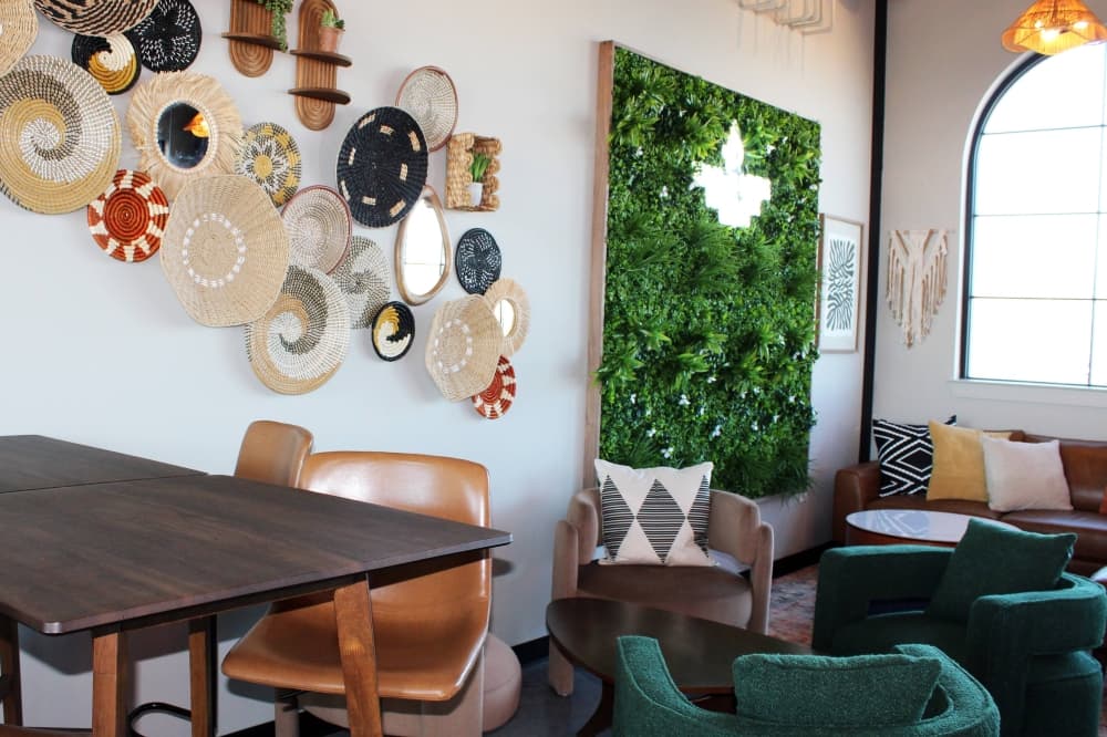 Interior of a business featuring tall table seating and low cushioned seating. 