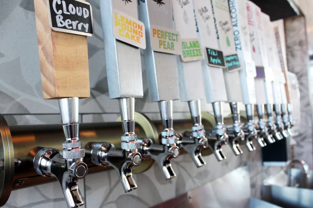 Taps featuring a variety of drink names on the handles. 