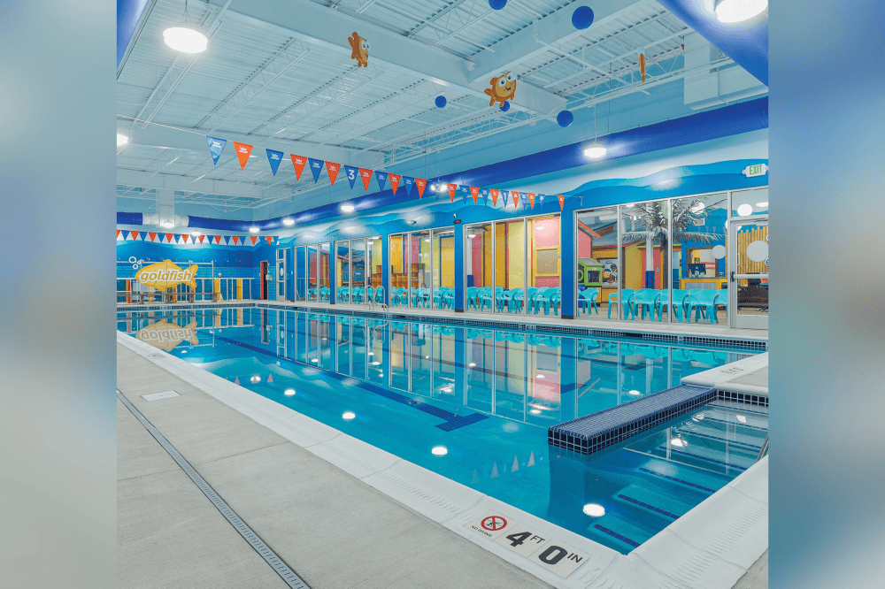 Kids swim class at Goldfish Swim School Northwest Hills featuring play-based swim lessons and lifeguard-trained instructors