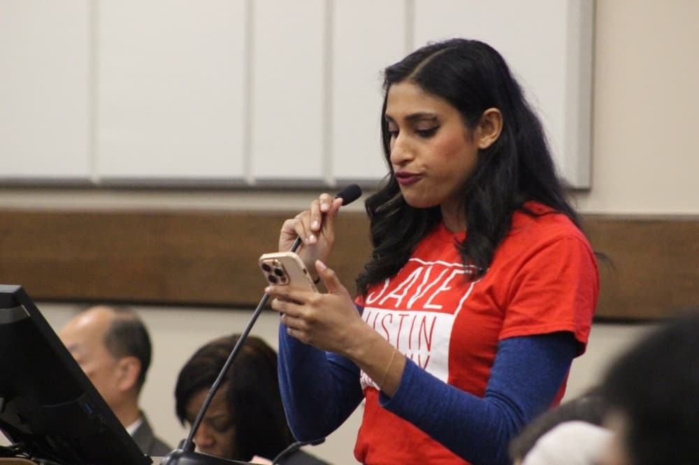 Several speakers wore red t-shirts with 'Save Austin Parkway.' (Aubrey Howell/Community Impact)