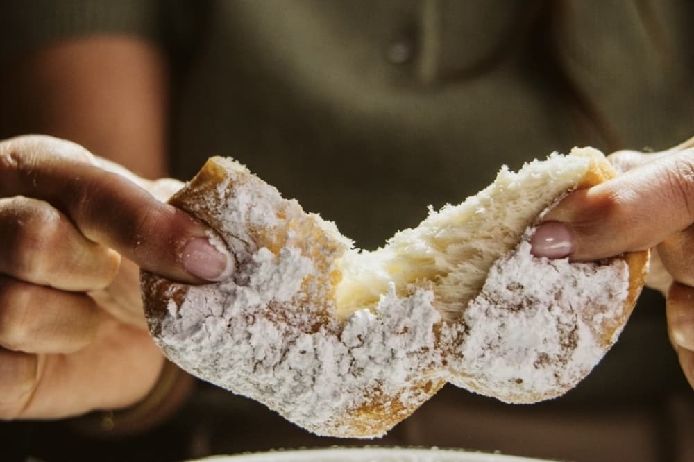 Beignets are made with powdered sugar and orange compote. (Courtesy Petite Suzette)
