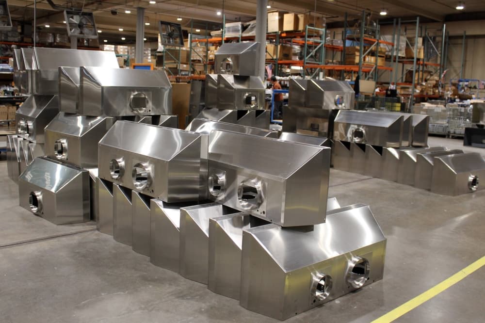 Stove ventilation canopies stacked in a manufacturing facility. 