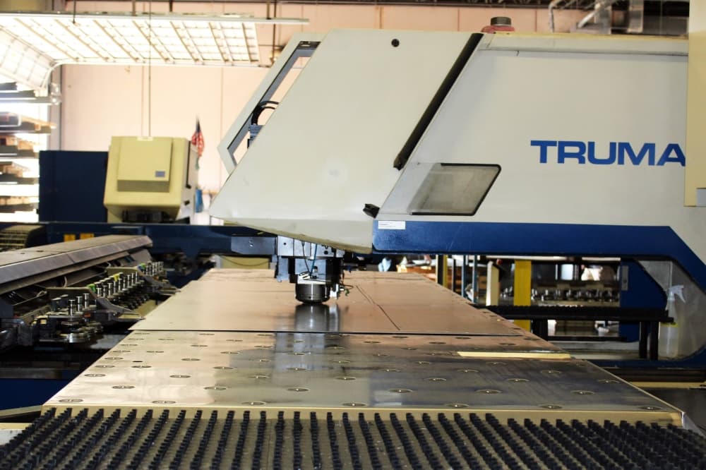 Large metal cutting machine cutting a sheet of metal.