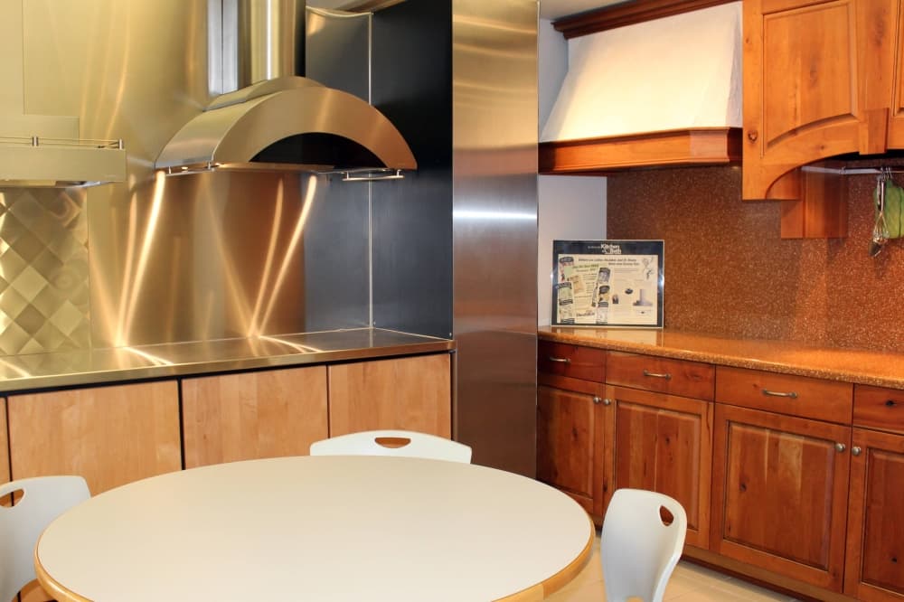 A variety of styles of stove ventilation canopies displayed in a dining area. 