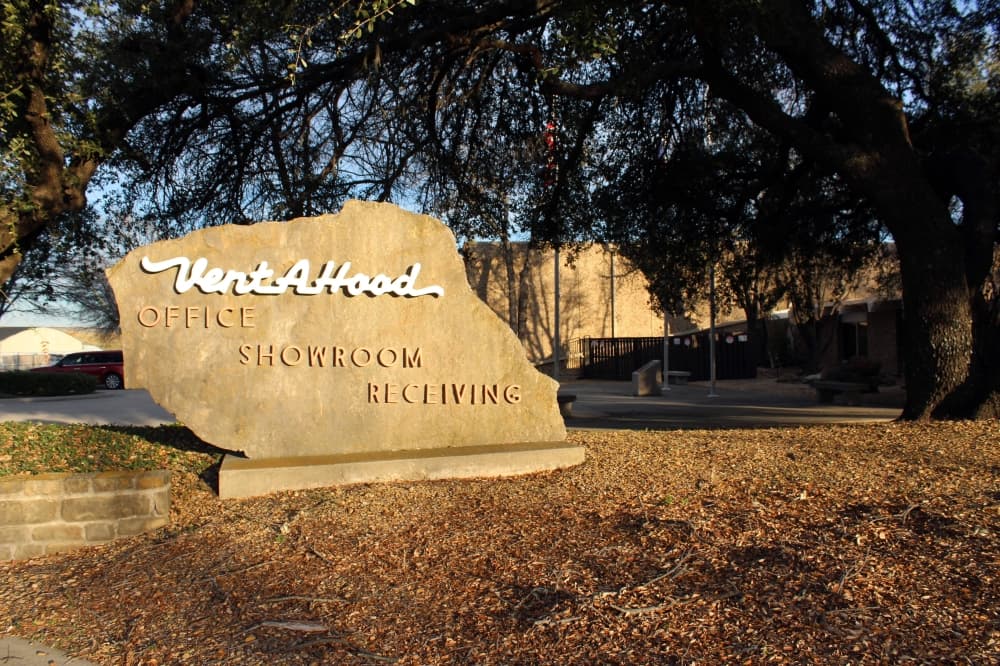 A rough stone monument sign features Vent-A-Hood logo signage. 