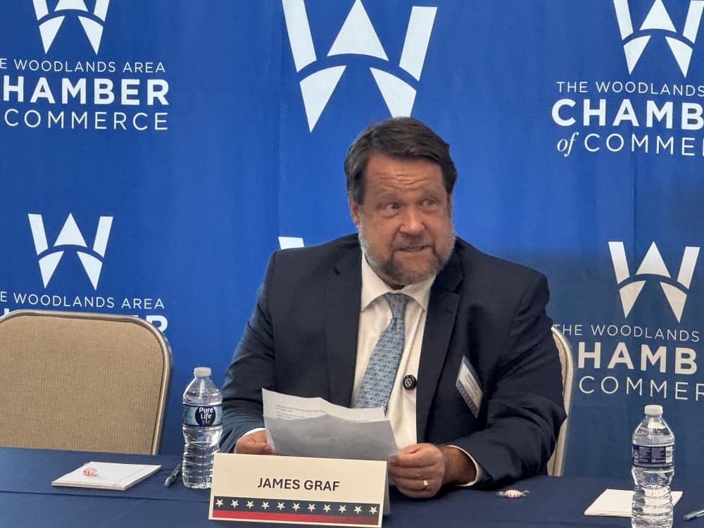 man in a suit at a debate table